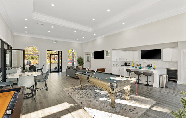 Community Clubhouse with Lounge Furniture and Game Tables at Shadow Ridge Apartments in Riverdale, GA.