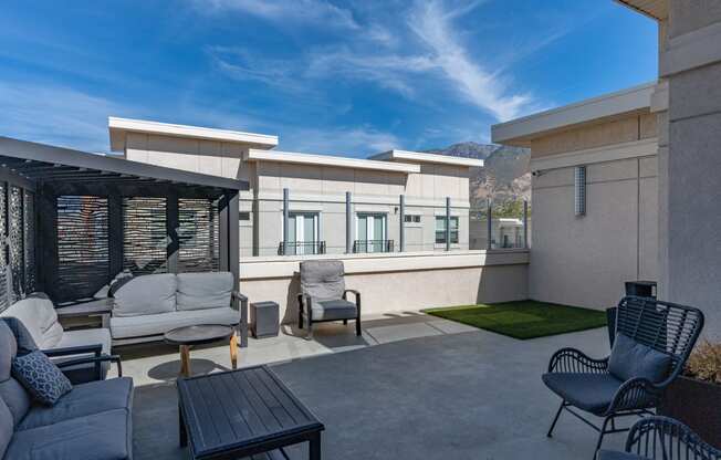 a patio with a couch and chairs and a table