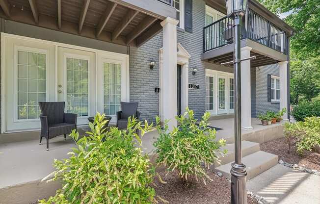 A house with a balcony and a small garden.