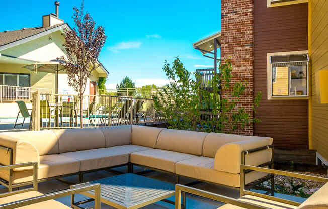 the patio of a house with a couch and tables at Skyview Apartments, Westminster