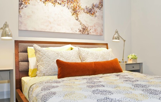 a bedroom with a bed and a painting on the wall