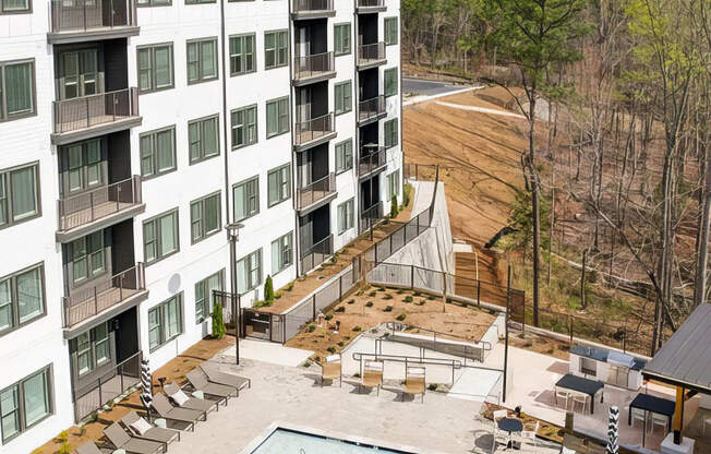 Large outdoor saltwater pool with deep and shallow areas and lounge seating at Novel Cary