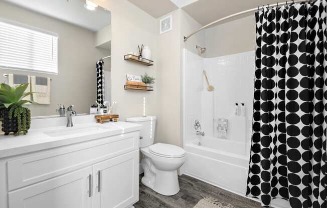 Estancia at Mission Grove Apartments Bathroom with white cabinets