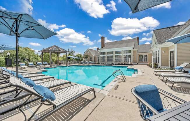 the resort style pool is surrounded by lounge chairs and umbrellas