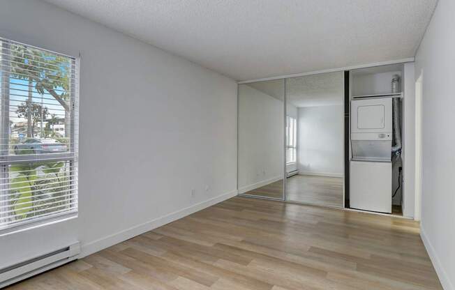 A room with a window and a sliding glass door.