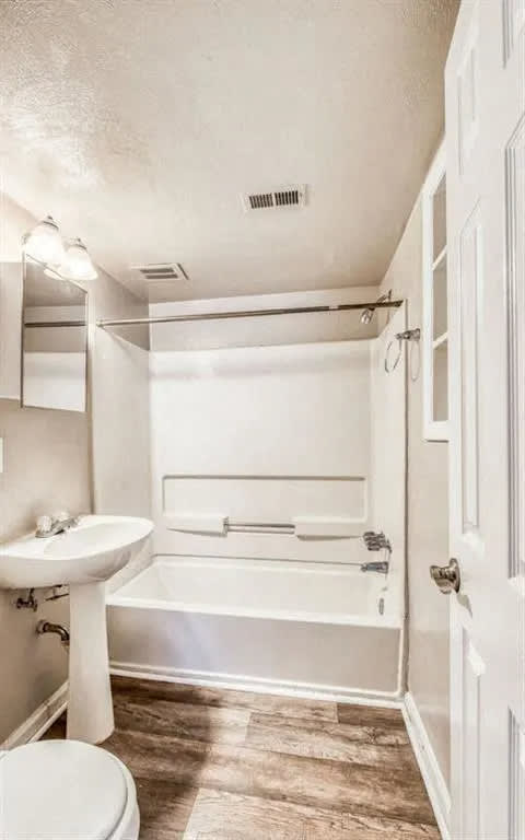 a bathroom with a sink and a bath tub at Gates of West Bay, Norfolk, 23503