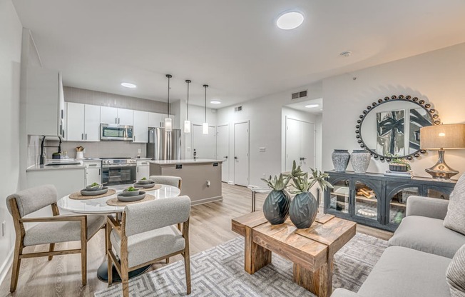 A modern kitchen with a dining table and chairs.