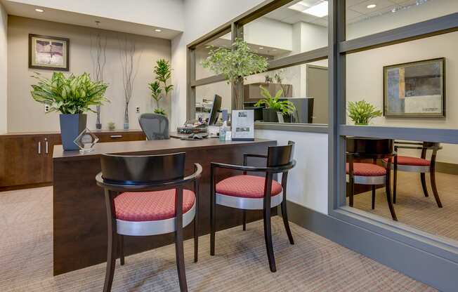 A reception area with a desk and two chairs.