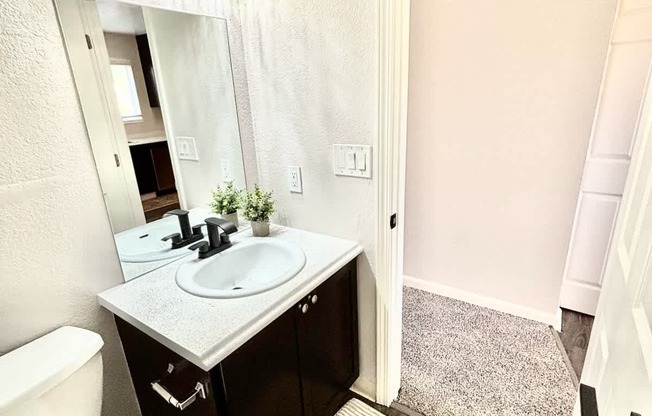 Campbell Plaza Apartments
710 Nido Drive, Campbell, CA 95008. A bathroom with a toilet, sink, and mirror.