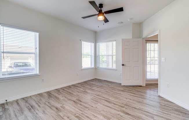 an empty room with colorful lights on the ceiling and a wooden floor