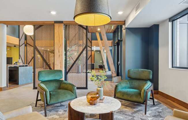 A modern living room with a wooden partition and green chairs.