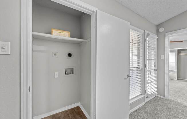 A white door is open to a hallway.