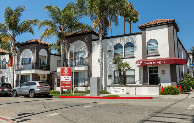 a building with palm trees in front of it on a street at Pacific Rose, Los Angeles, CA 90034