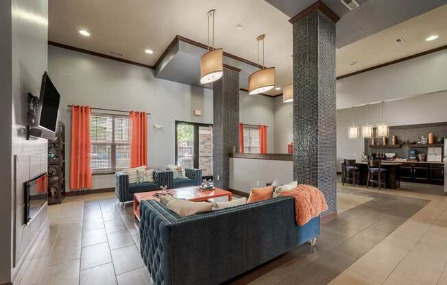 the lobby of a clubhouse with couches and a table