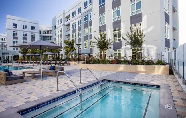 a swimming pool with a building in the background