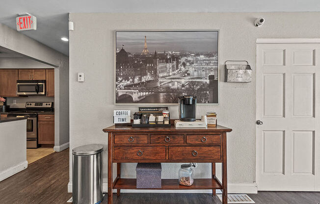 a kitchen with a table and a painting on the wall