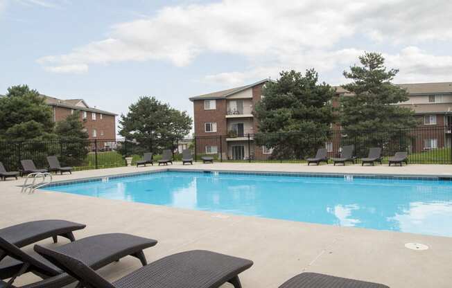 Swimming pool with lounge chairs at Northridge Heights apartments in North Lincoln