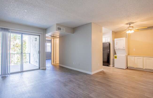 an open living room with a door leading to a balcony