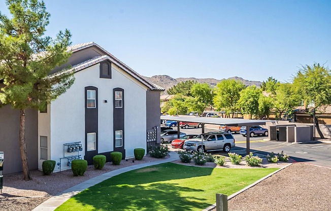 A white house with a grey roof and a green lawn in front at Sterling Point Apartment Homes, Phoenix