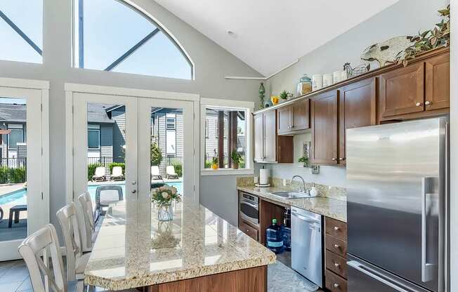 A kitchen with a marble countertop and stainless steel appliances in the clubhouse at The Landing Apartments and Townhomes, Oregon, 97045