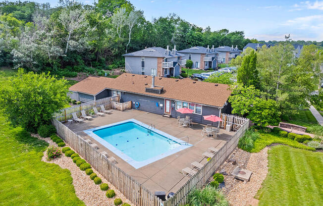 an aerial view of a swimming pool in a backyard