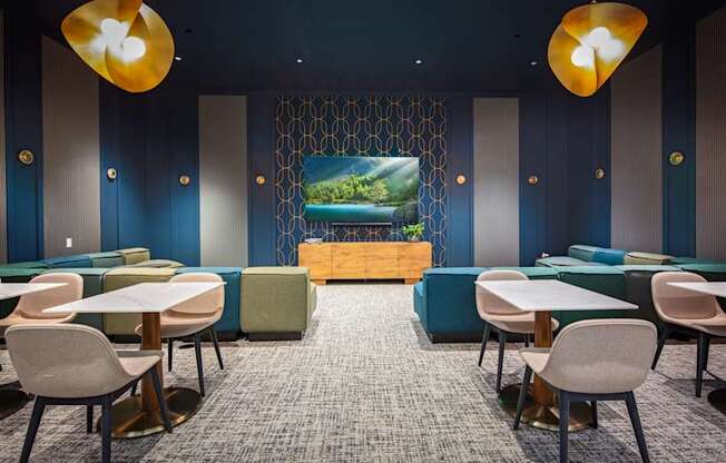 A room with tables and chairs and a screen in the middle.