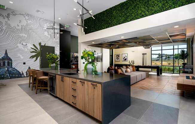 A modern kitchen with a green wall.
