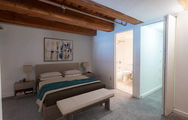 a bedroom with a bed and a bathroom at Lowertown Commons Apartments, Minnesota, 55101