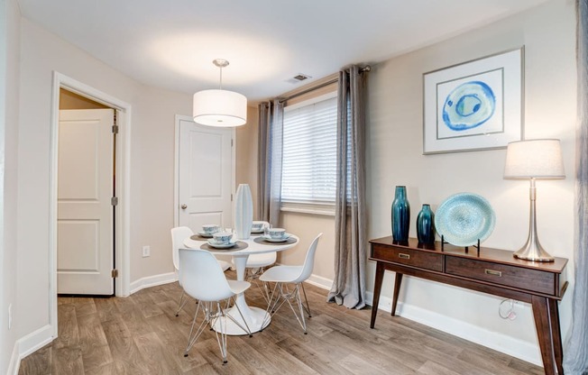 a dining room with a table and chairs