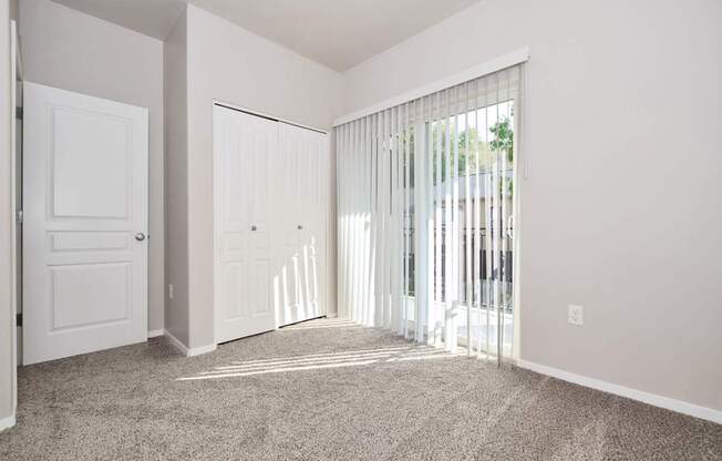 A room with a carpeted floor and white walls.