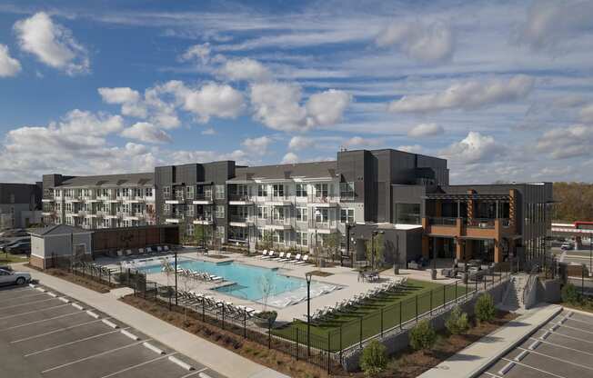 an aerial view of an apartment building with a swimming pool