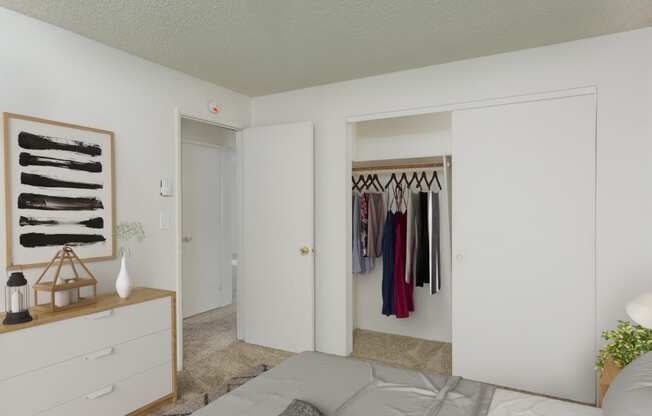 a bedroom with a closet and a bed and a dresser with clothes hanging on