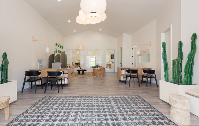 a living room with tables and chairs and a rug