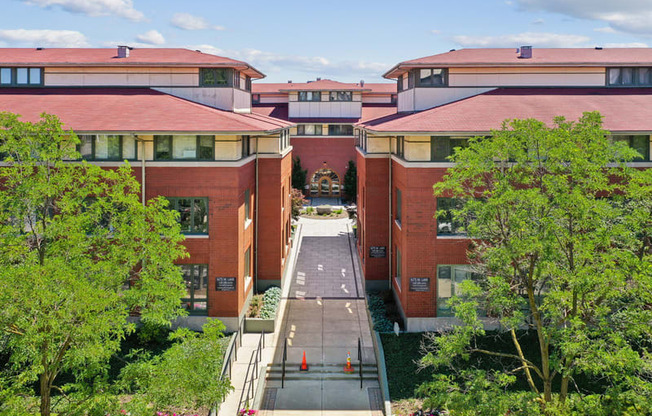 A red brick building with a walkway in front.