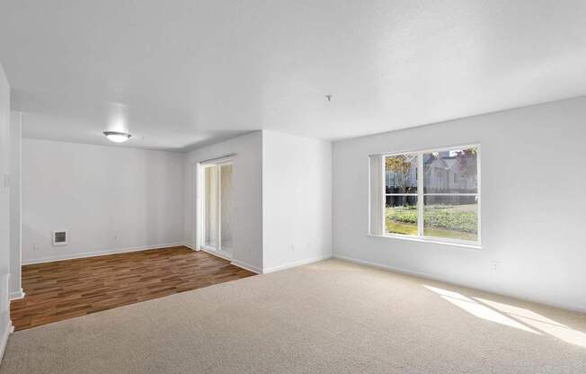 a living room with white walls and a window