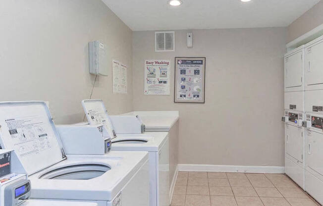 a laundry room with four washes and a dryer