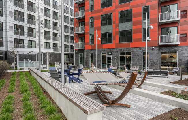 courtyard with lounge chairs and hammocks at the district flats apartments