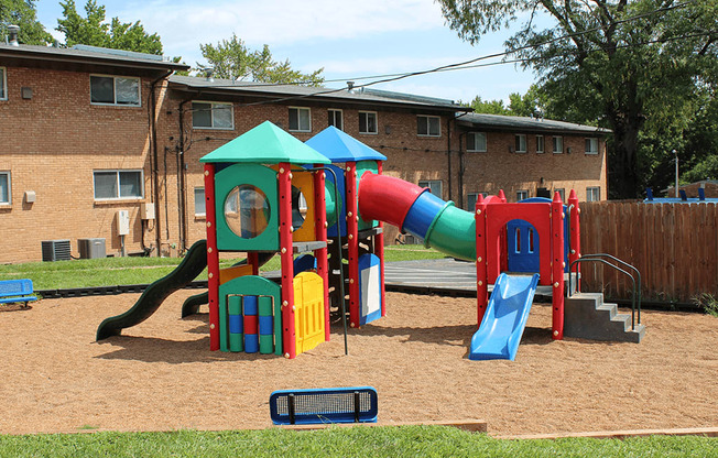 a playground with a slide and other playground equipment in a yard