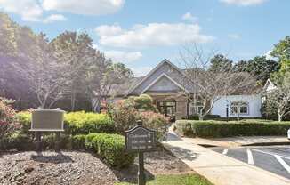 A sign in front of a building that says Clubhouse.