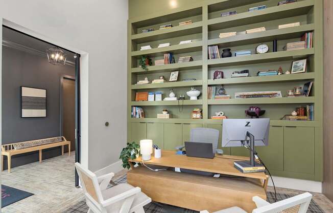 A room with a desk, chair, and bookshelf.
