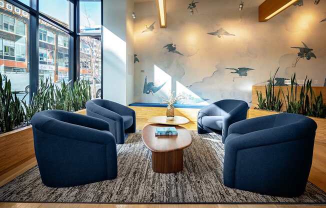 A room with blue chairs and a table with a tray on it.