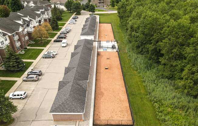 A long parking lot with cars parked in it.