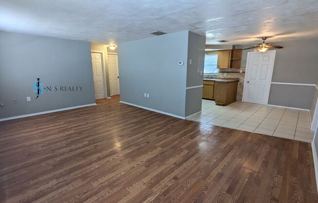 Must See 3/2/1 over 1000sf with tile/laminate floors, fresh paint, fenced yard and large living room!!