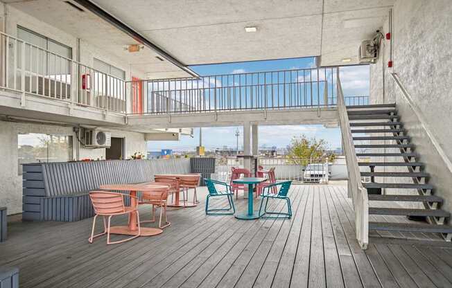 A wooden deck with chairs and a table.