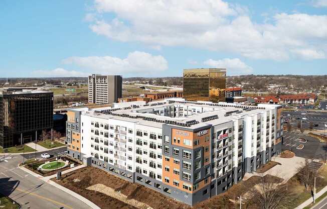 A large multi-story building with a parking lot in front.