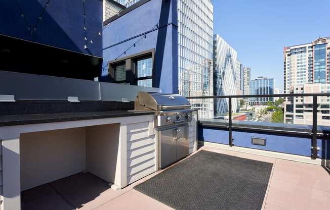 a kitchen with a grill and a city skyline in the background
