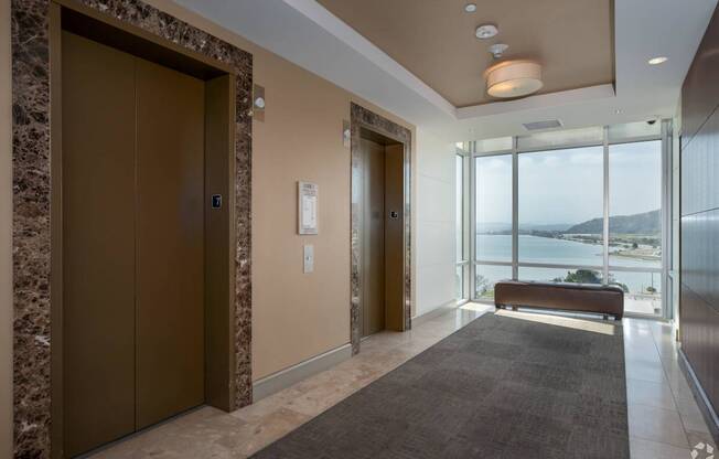 A modern hallway with a brown door and a bench.