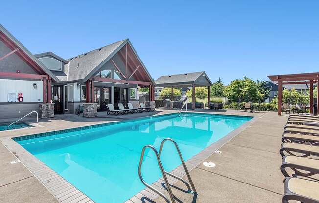 A large swimming pool with lounge chairs at The Landing Apartments and Townhomes, Oregon, 97045