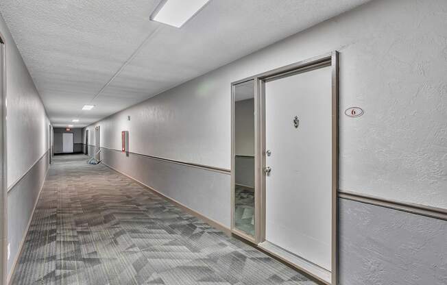 A long hallway with a door on the right.