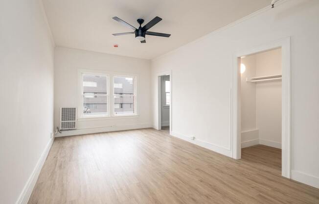 A room with a ceiling fan and a window at Westmore Manor Apartments, Los Angeles, California